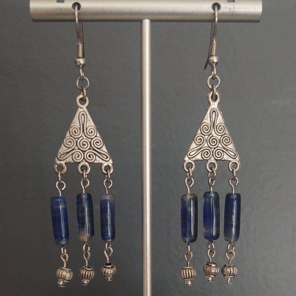 Textured silver earrings with blue glass dangles